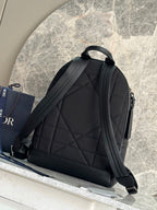 Dark green leather-look backpack with quilted panel and adjustable shoulder straps.