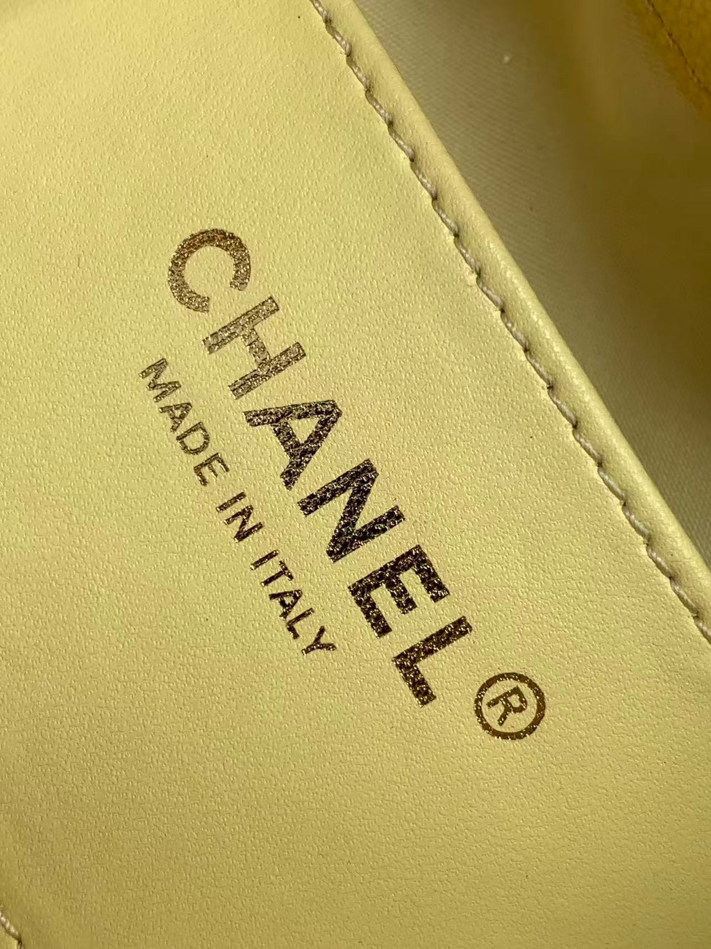 Chanel bag Made in Italy leather stamp on pale yellow interior panel.