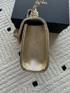 Chanel small top-handle bag in textured finish with chain strap and gold clasp