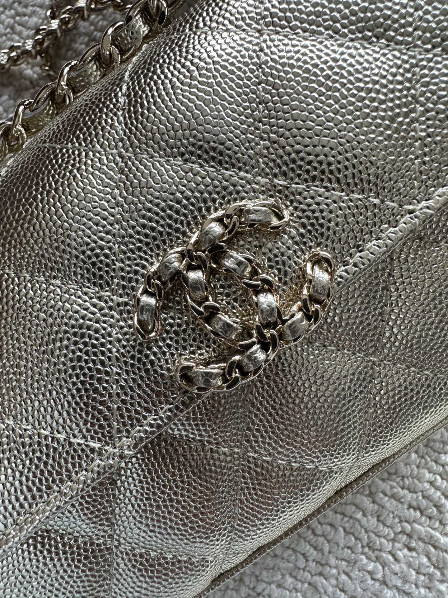 Chanel textured metallic bag close-up with chain strap and clasp hardware