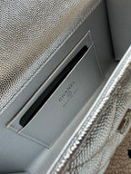Light silver bag interior card slot with Chanel text branding on divider