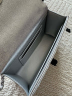 Light silver bag interior opening with smooth lining and stitched inner seams