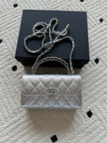 Chanel quilted flap bag in light silver with top handle and chain shoulder strap