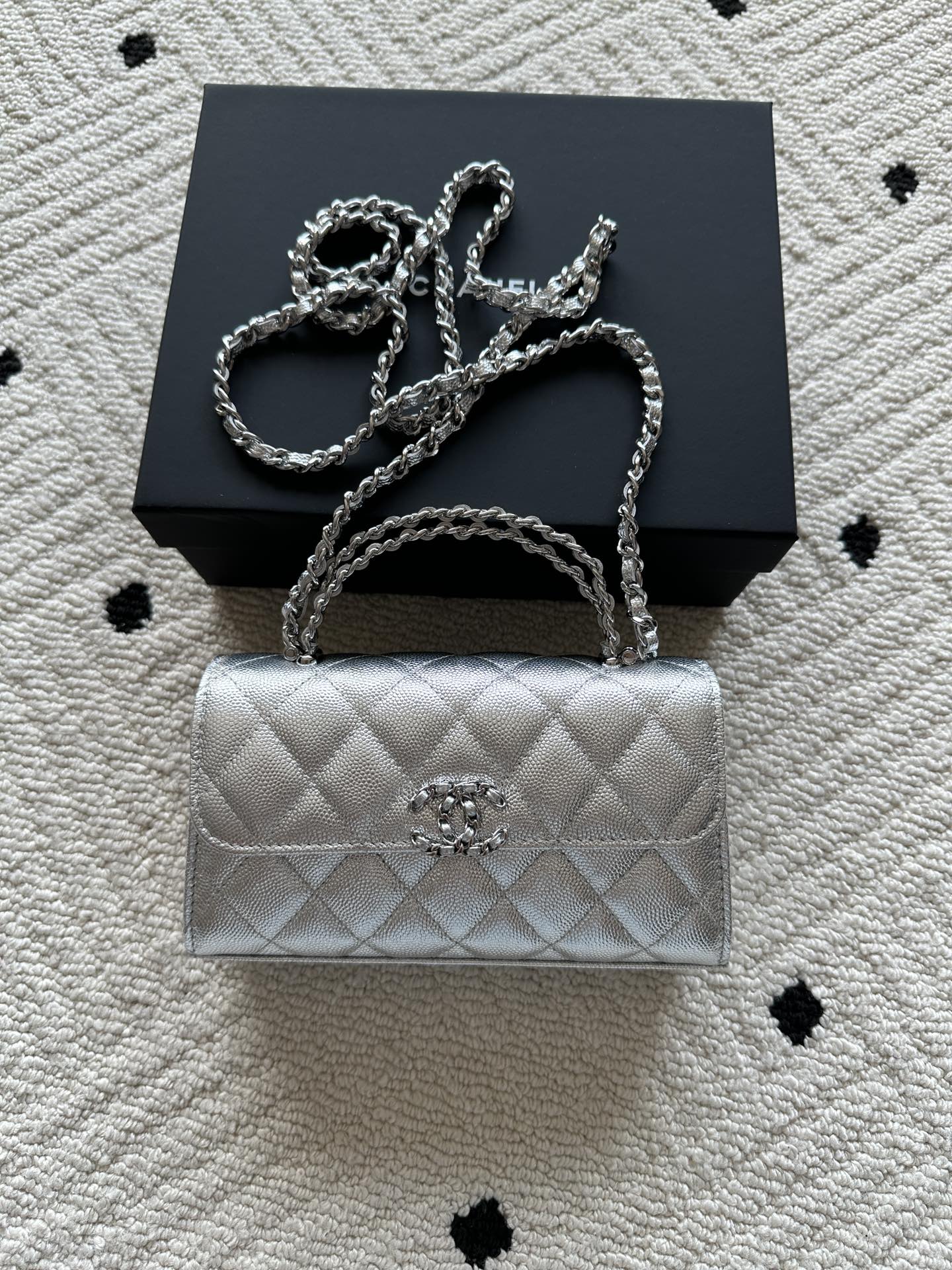 Chanel quilted flap bag in light silver with top handle and chain shoulder strap