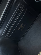 Black leather lining with embossed CHANEL text and stitched compartment seams
