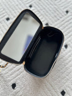 Zippered black interior pouch with card slot and open pocket