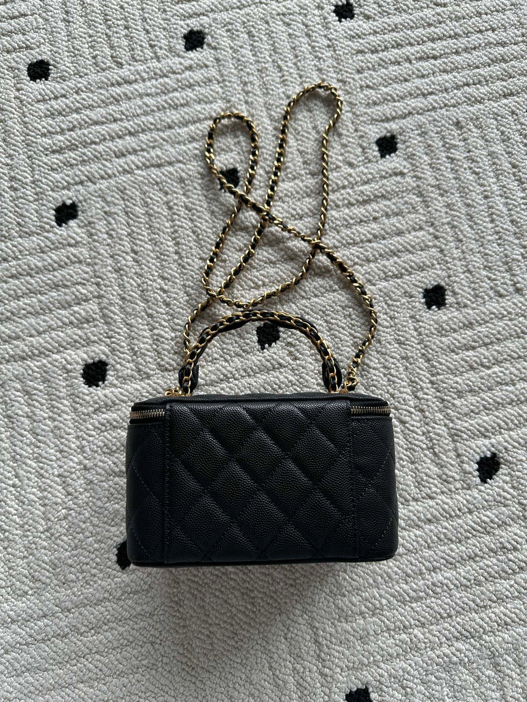 Small black quilted handbag with gold chain strap and CC logo on front