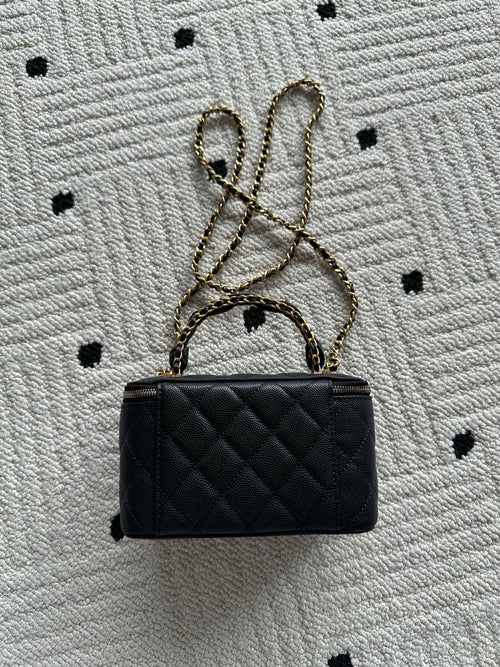Small black quilted handbag with gold chain strap and CC logo on front