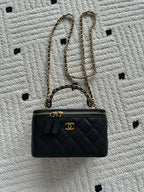 Chanel small quilted leather handbag with gold chain strap and CC front logo