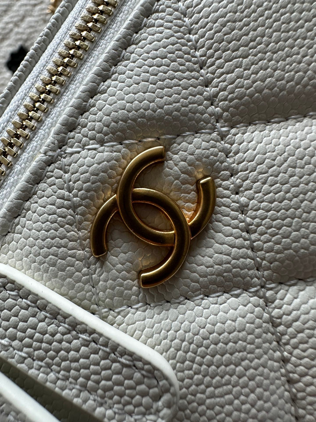 White quilted mini handbag with gold-tone CC charm on the front