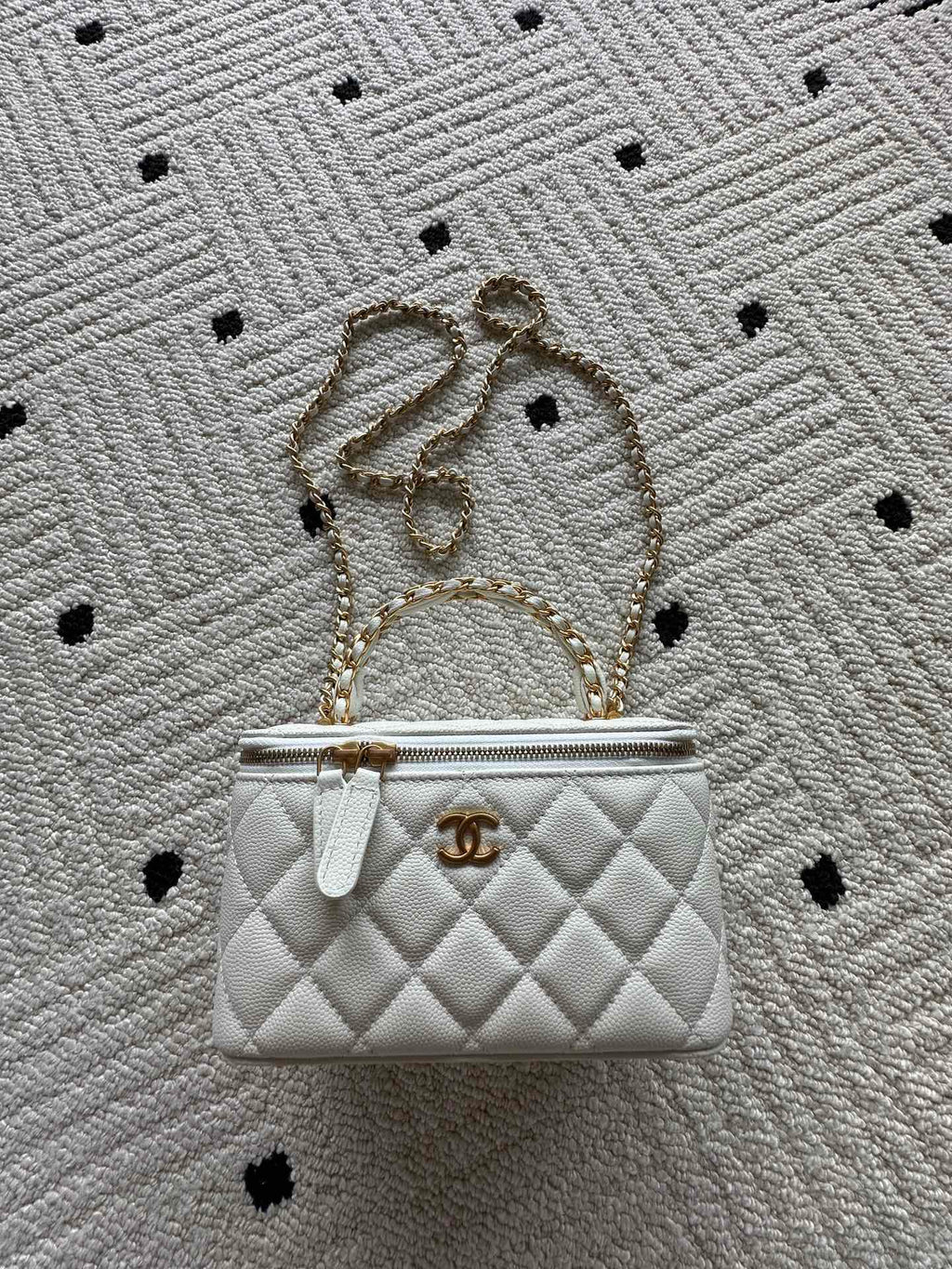 White quilted mini handbag with gold chain strap and CC clasp hardware