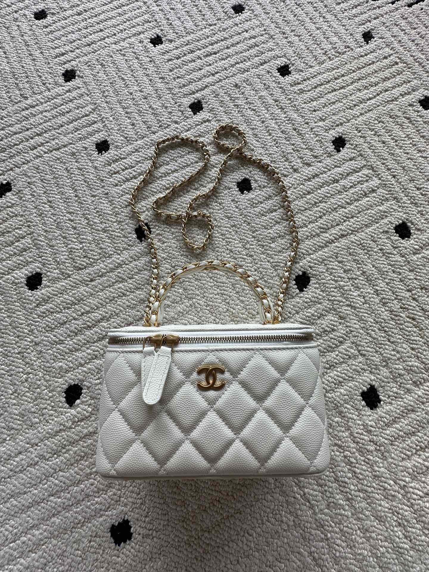 White quilted mini handbag with gold chain strap and CC clasp hardware