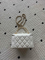 White quilted mini handbag with gold chain strap and CC hardware, front view