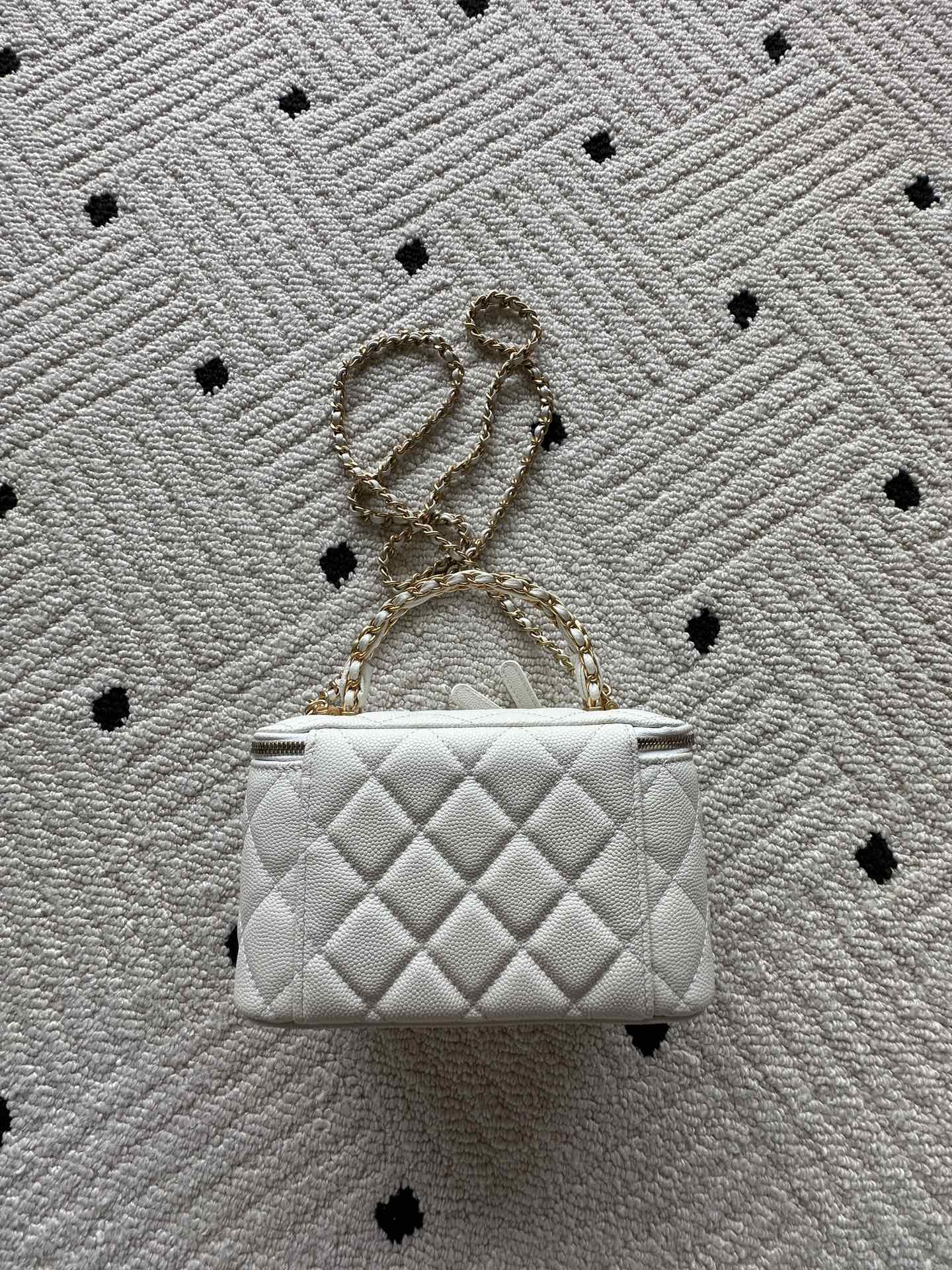 White quilted mini handbag with gold chain strap and CC hardware, front view