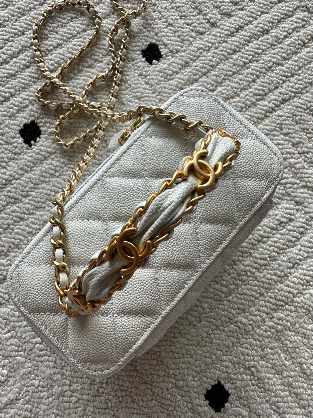White quilted mini handbag with gold chain strap and leather shoulder detail