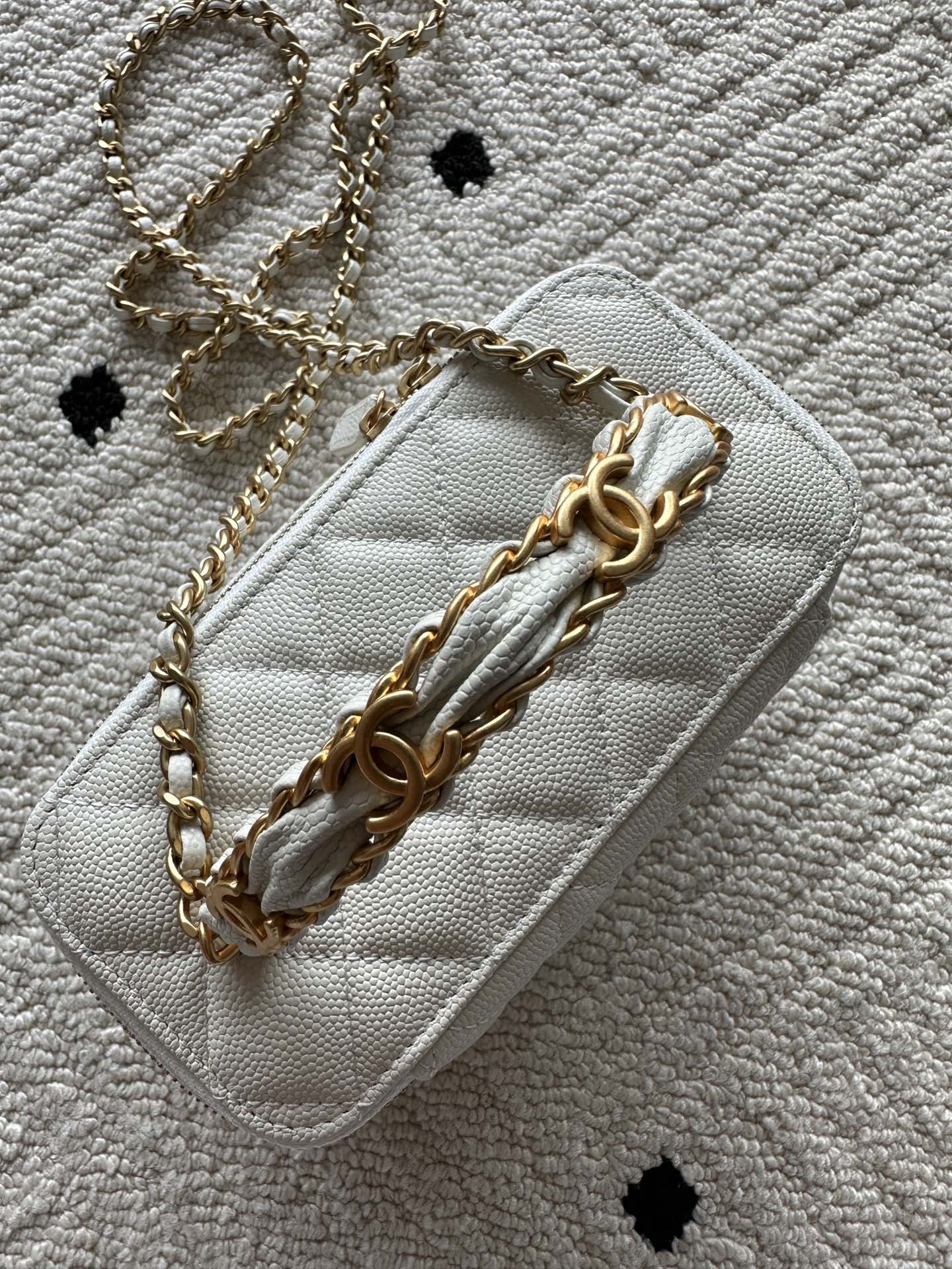 White quilted mini handbag with gold chain strap and leather shoulder detail