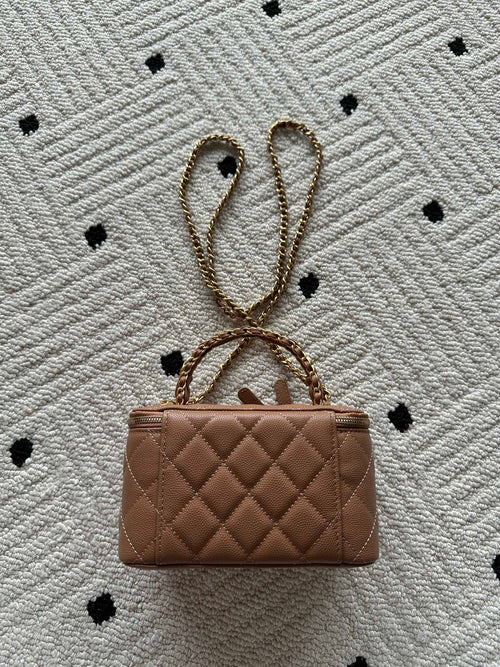Chanel bag in tan-brown quilted leather with chain strap and small top clasp.