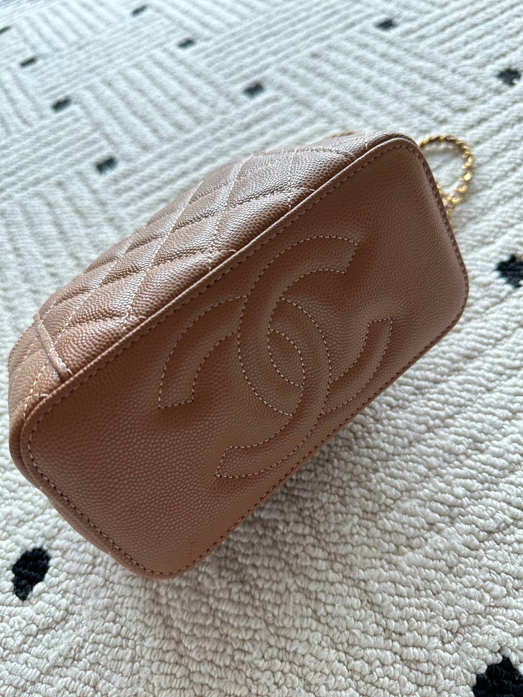 Chanel bag tan-brown quilted leather with embossed CC on front flap.