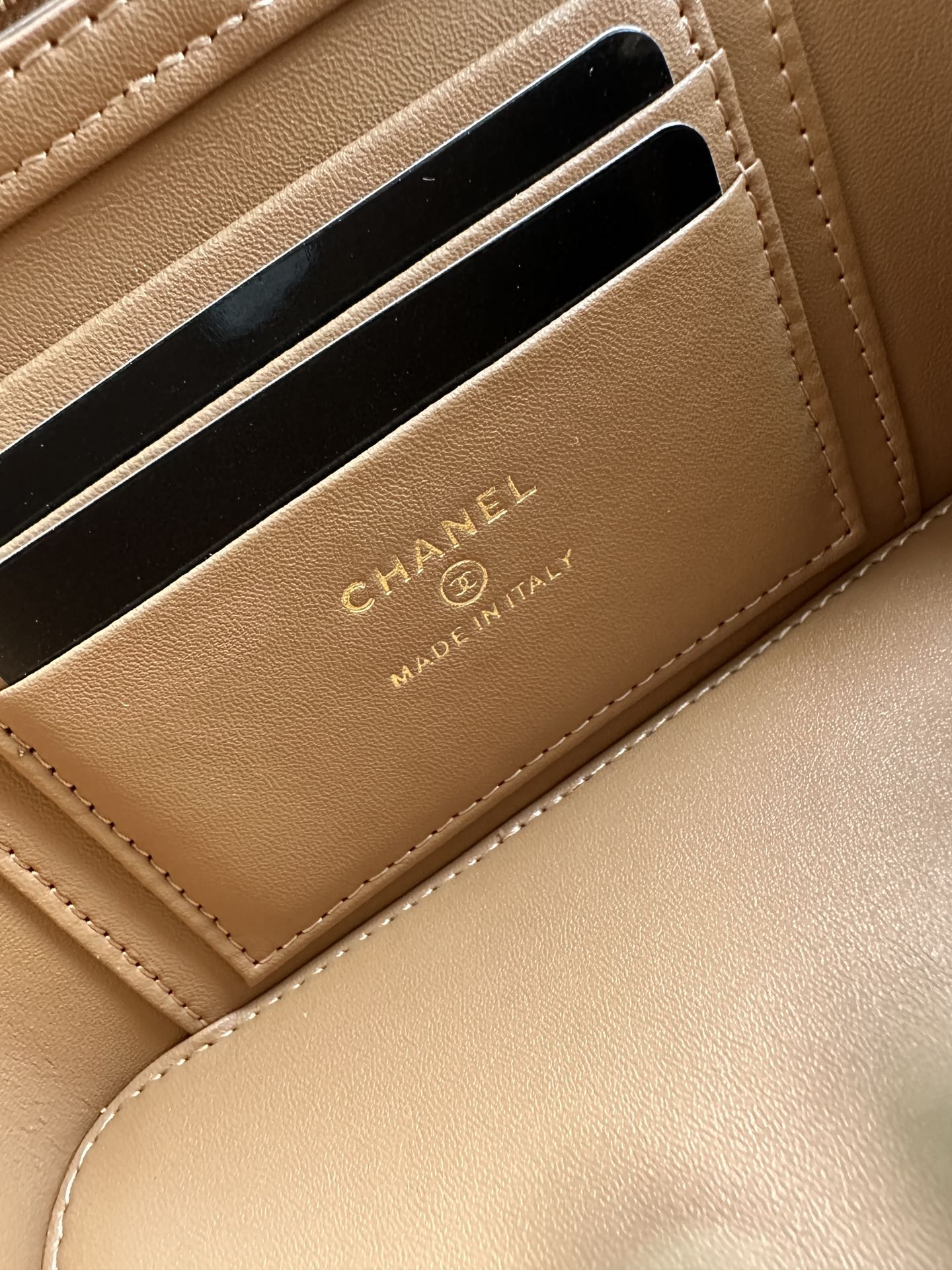 Chanel bag tan-brown leather with card slots and gold CHANEL marking.
