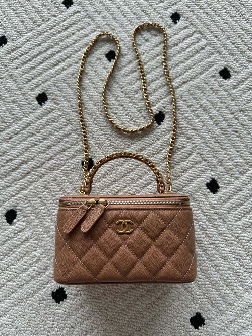 Chanel bag in tan-brown quilted leather with chain strap and top clasp.
