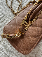 Chanel bag tan-brown quilted leather with gold-tone chain on front flap.
