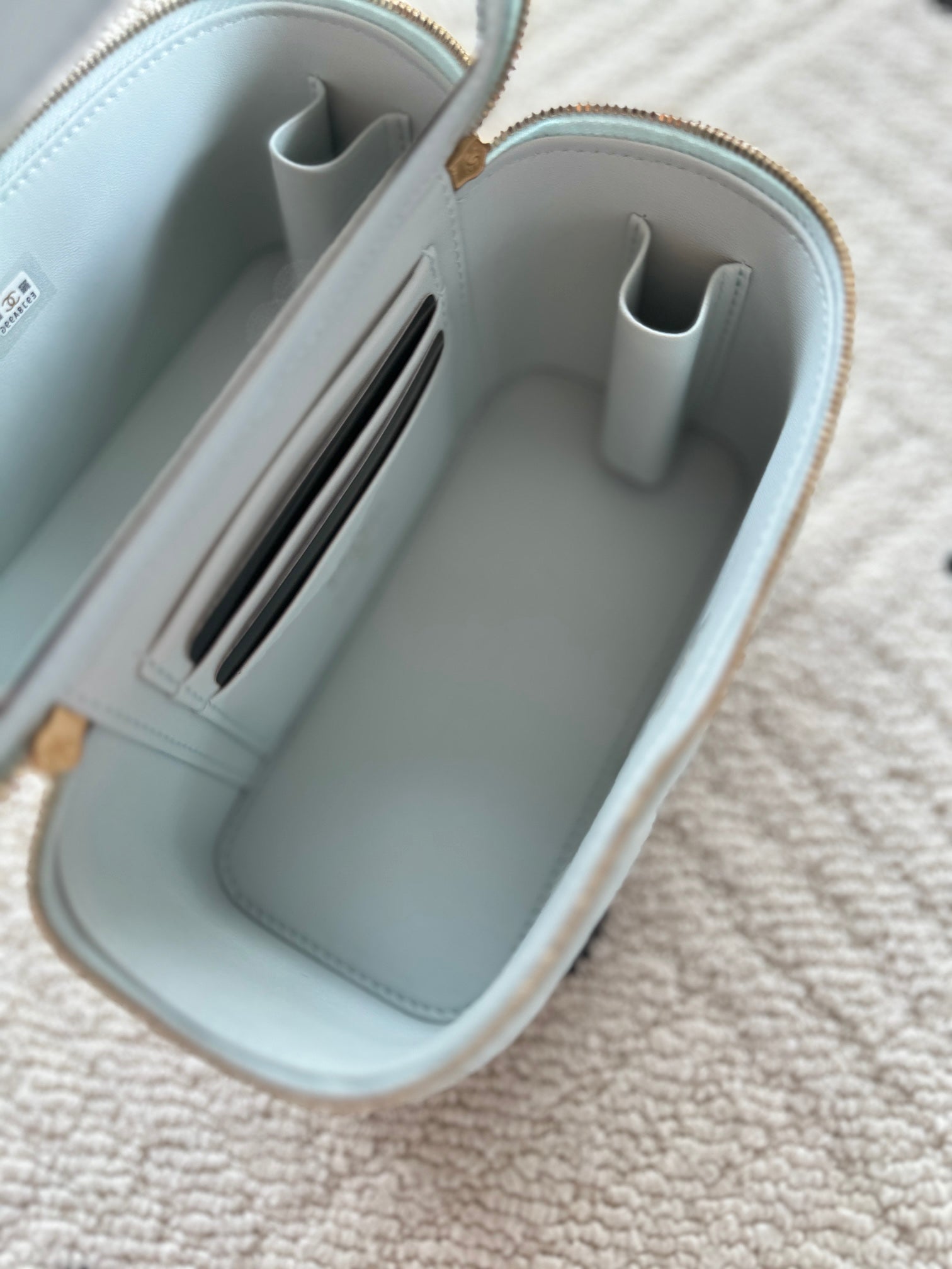 Light-blue mini bag interior with card slots and inner zipper pouch
