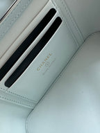 Light-blue card holder compartment with Chanel text and embossed slot design