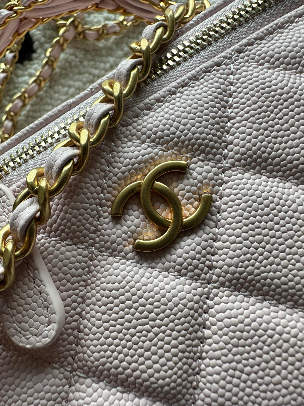 Chanel mini bag in pink with gold chain, zipper detail, and logo charm