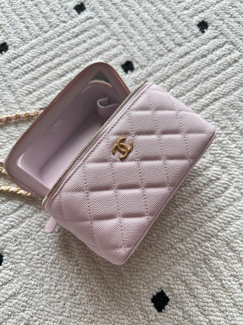 Chanel mini wallet bag in pink open to show interior with logo pull
