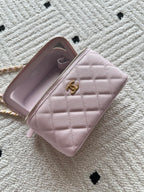 Chanel mini wallet bag in pink open to show interior with logo pull
