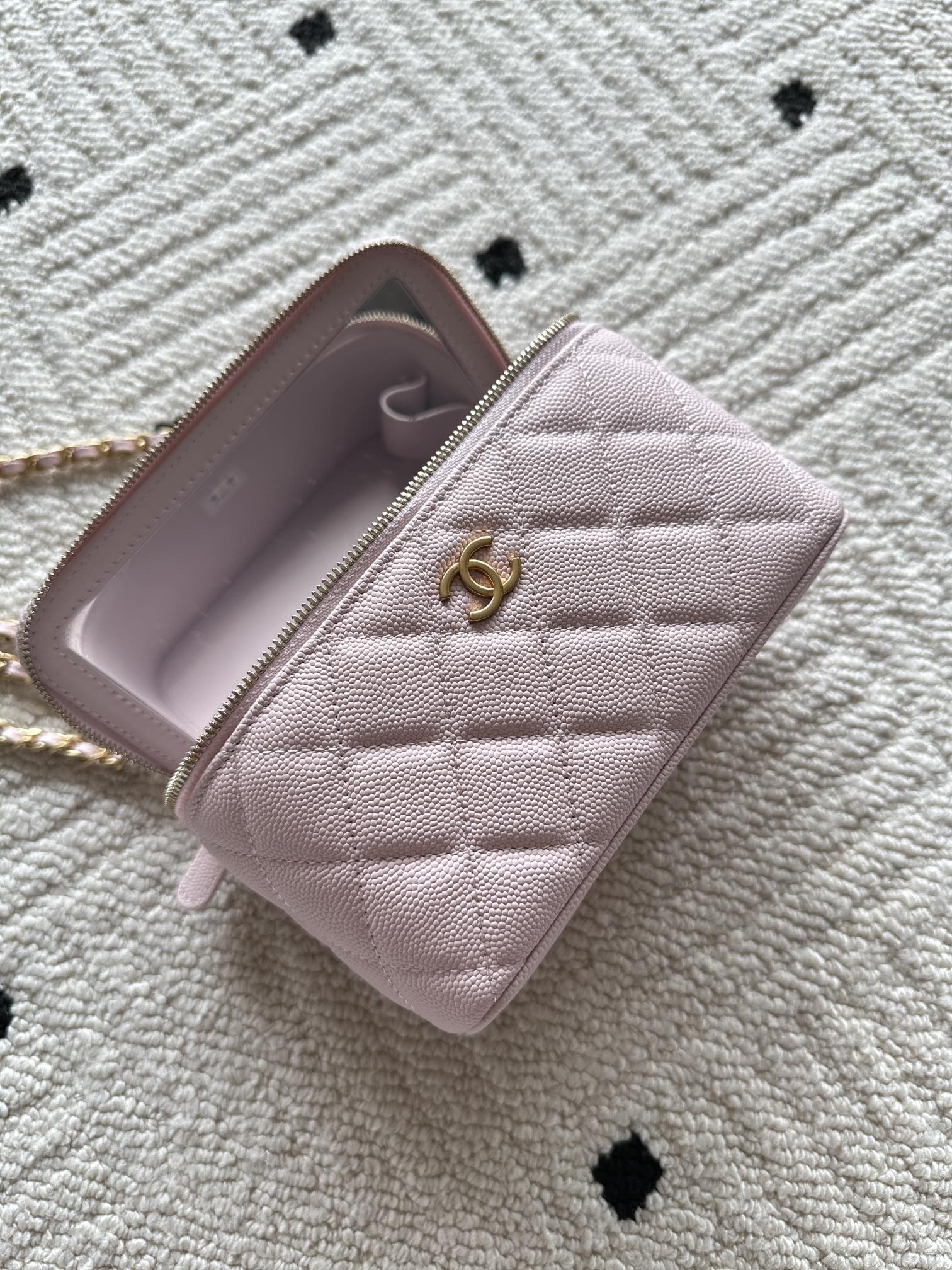 Chanel mini wallet bag in pink open to show interior with logo pull