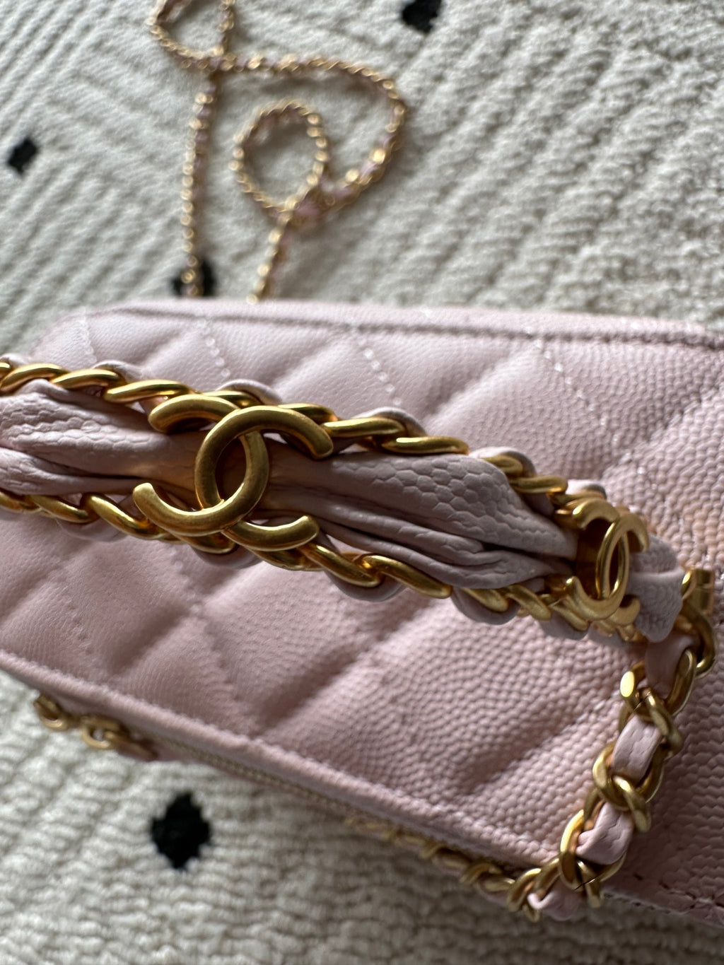 Chanel mini bag in pink with front chain over flap and gold clasp hardware