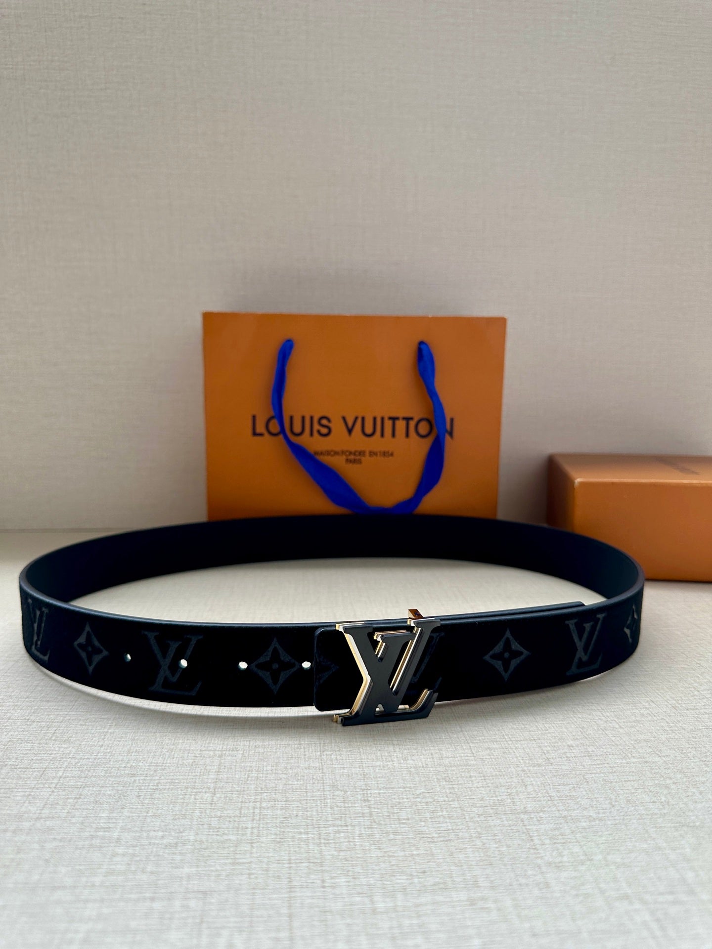 Louis Vuitton monogram belt with navy strap and gold-tone LV buckle