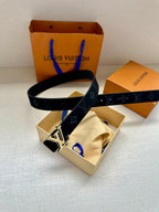 Louis Vuitton navy monogram belt with gold-tone buckle on display, boxed