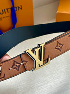 Louis Vuitton belt close-up: brown monogram strap with gold-tone LV buckle