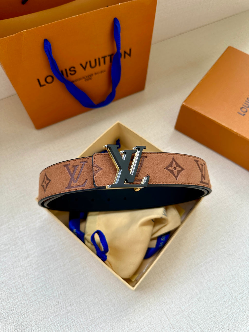Louis Vuitton belt in open box: brown monogram strap with gold-tone LV buckle