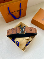 Louis Vuitton belt in open box: brown monogram strap with gold-tone LV buckle