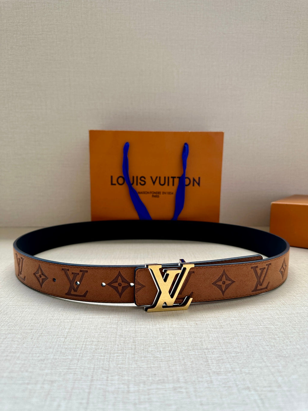 Louis Vuitton belt with brown monogram canvas and gold-tone LV buckle, dark lining