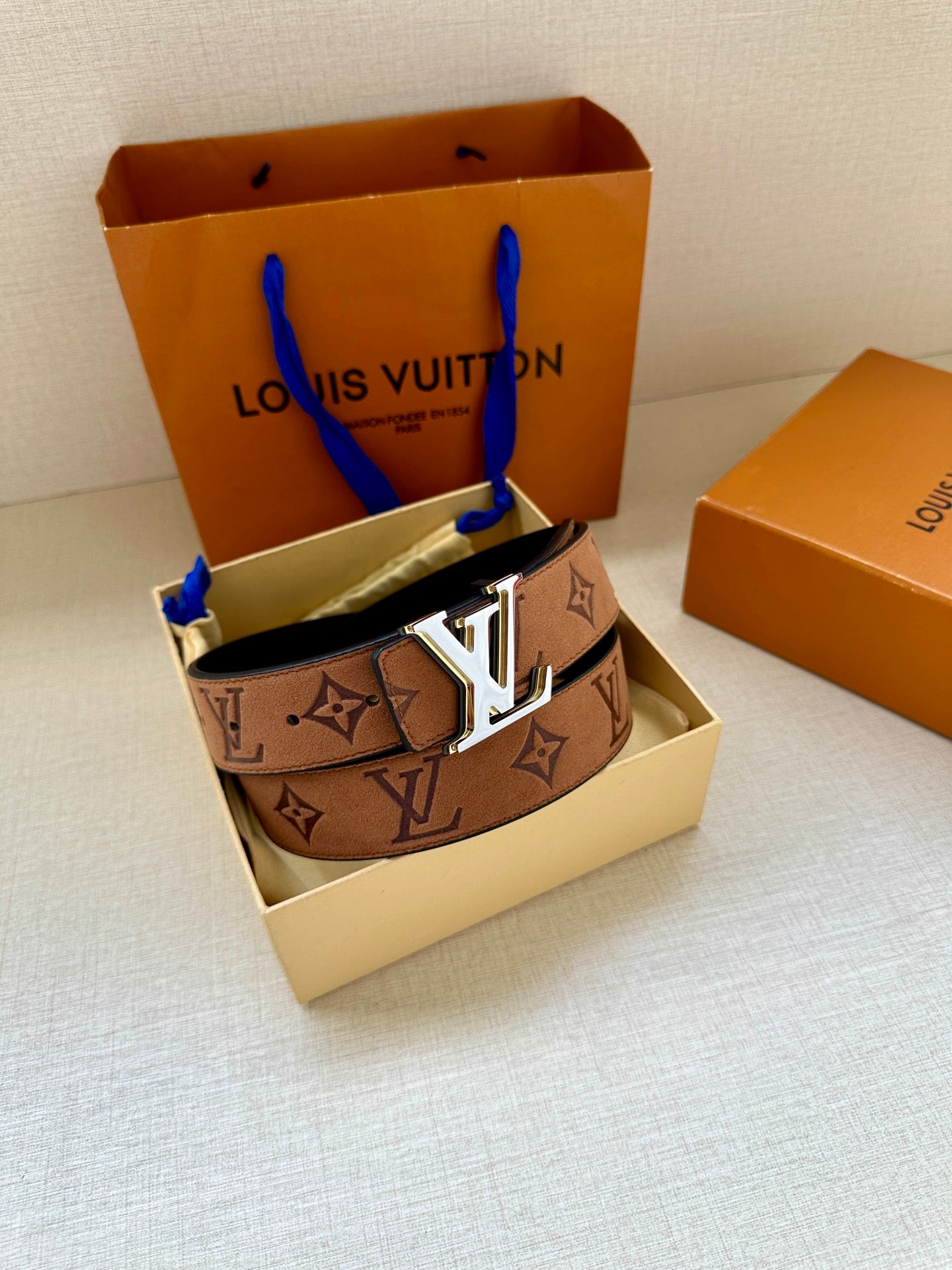 Louis Vuitton belt in box with brown monogram strap and gold-tone LV buckle