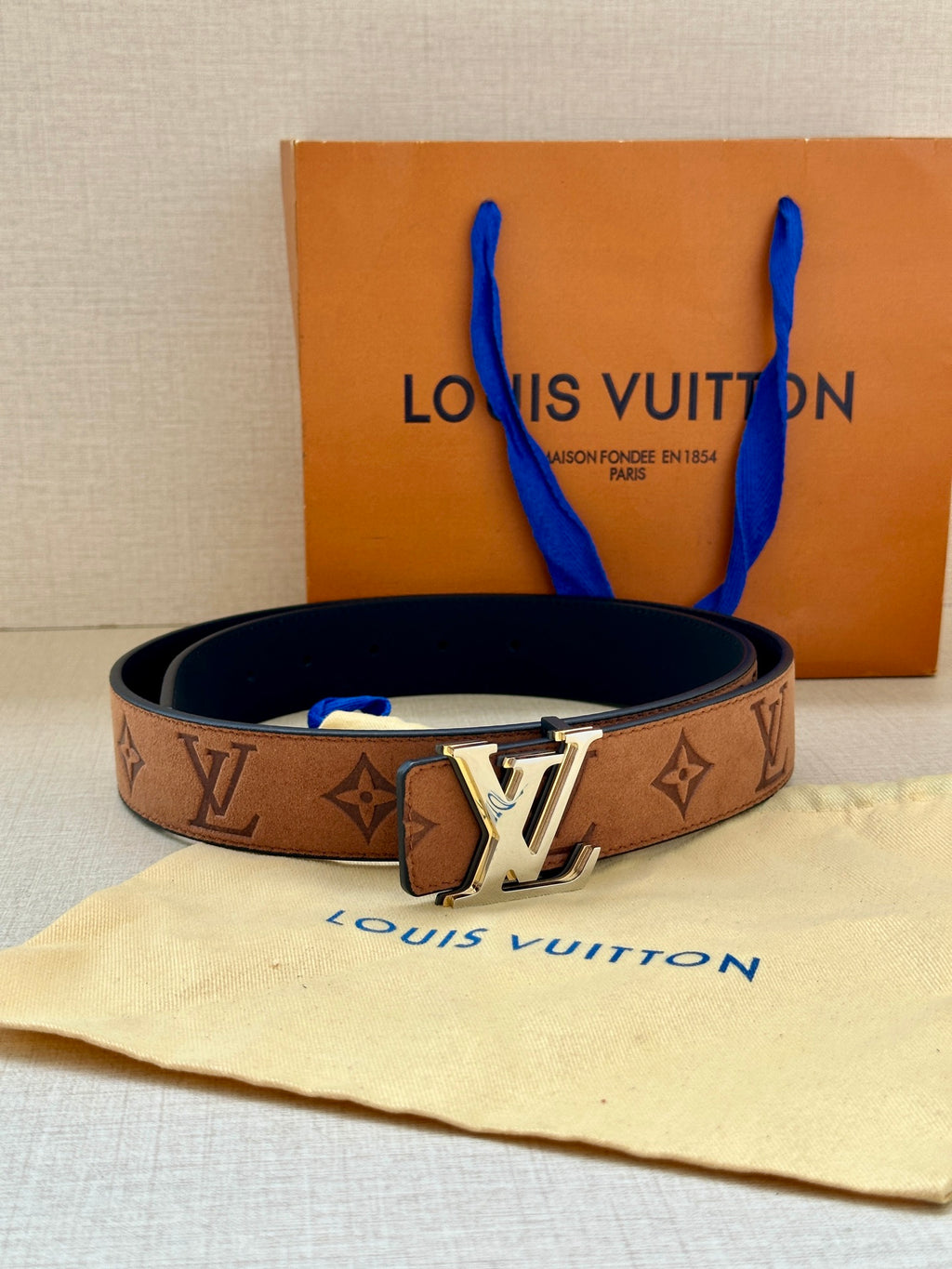 Louis Vuitton belt with brown monogram canvas, gold-tone LV buckle, dark lining