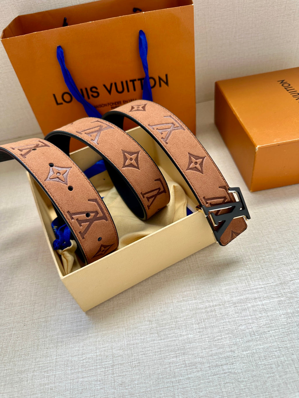 Louis Vuitton belt set in box: three brown monogram straps with gold-tone buckles