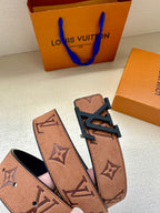 Louis Vuitton belt close-up: tan monogram strap with gold-tone buckle, belt ends