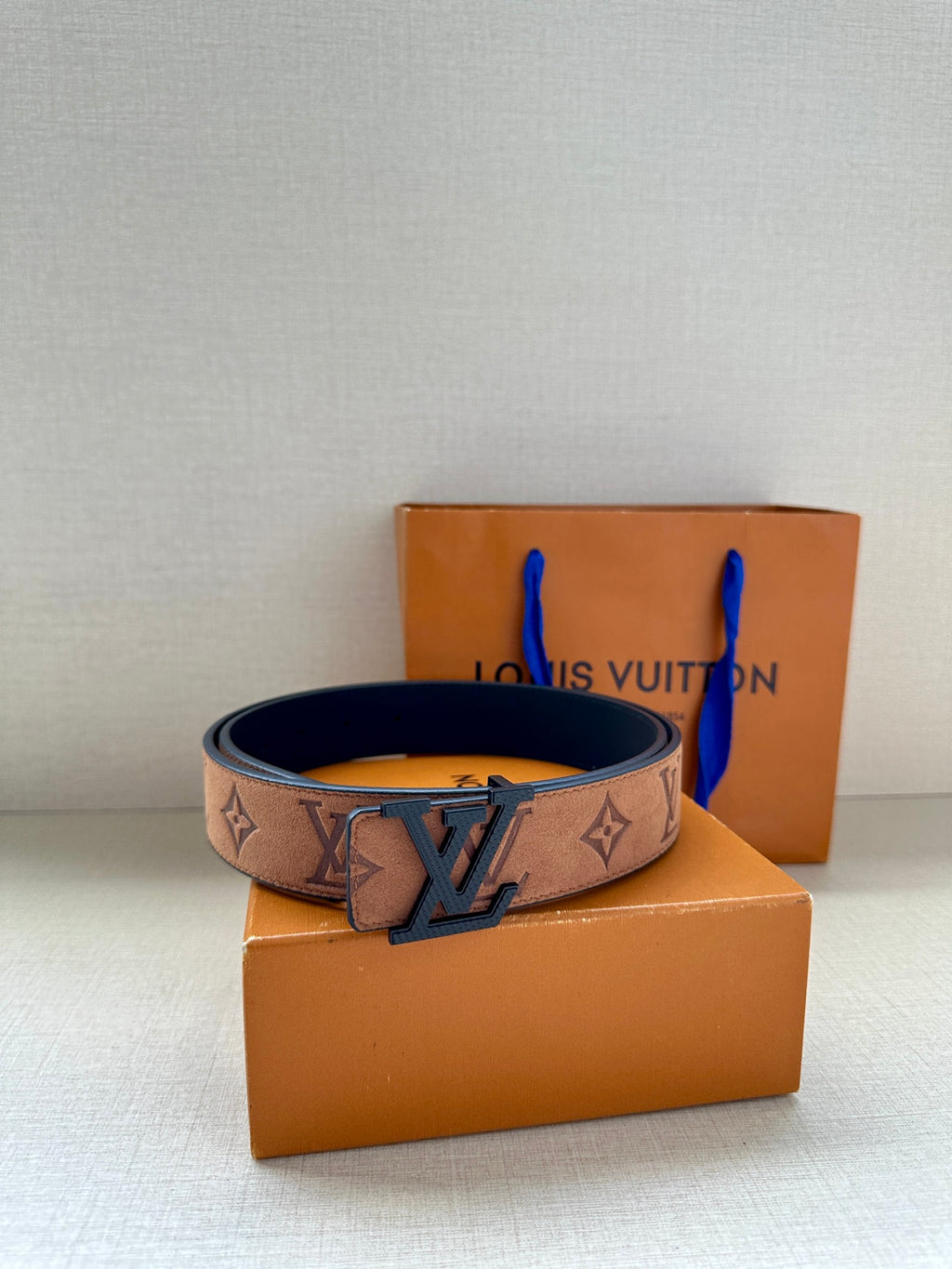 Louis Vuitton monogram belt with tan strap and gold-tone buckle on top box style