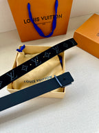 Dark blue monogram belt with silver LV buckle and black strap; buckle sits on leather end.