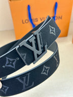 Dark blue monogram belt viewed at angle, silver LV buckle with textured trim.