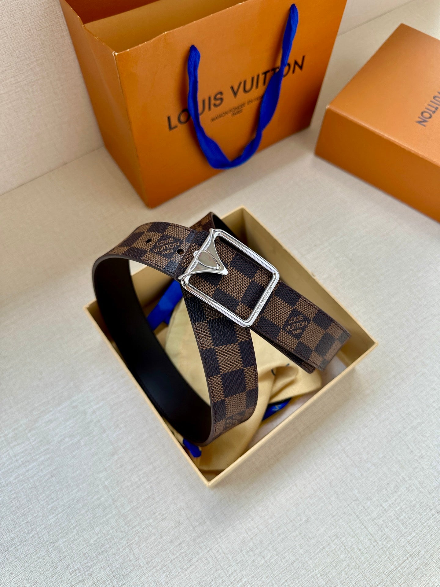 Damier check belt with dark leather strap and silver-toned buckle in box