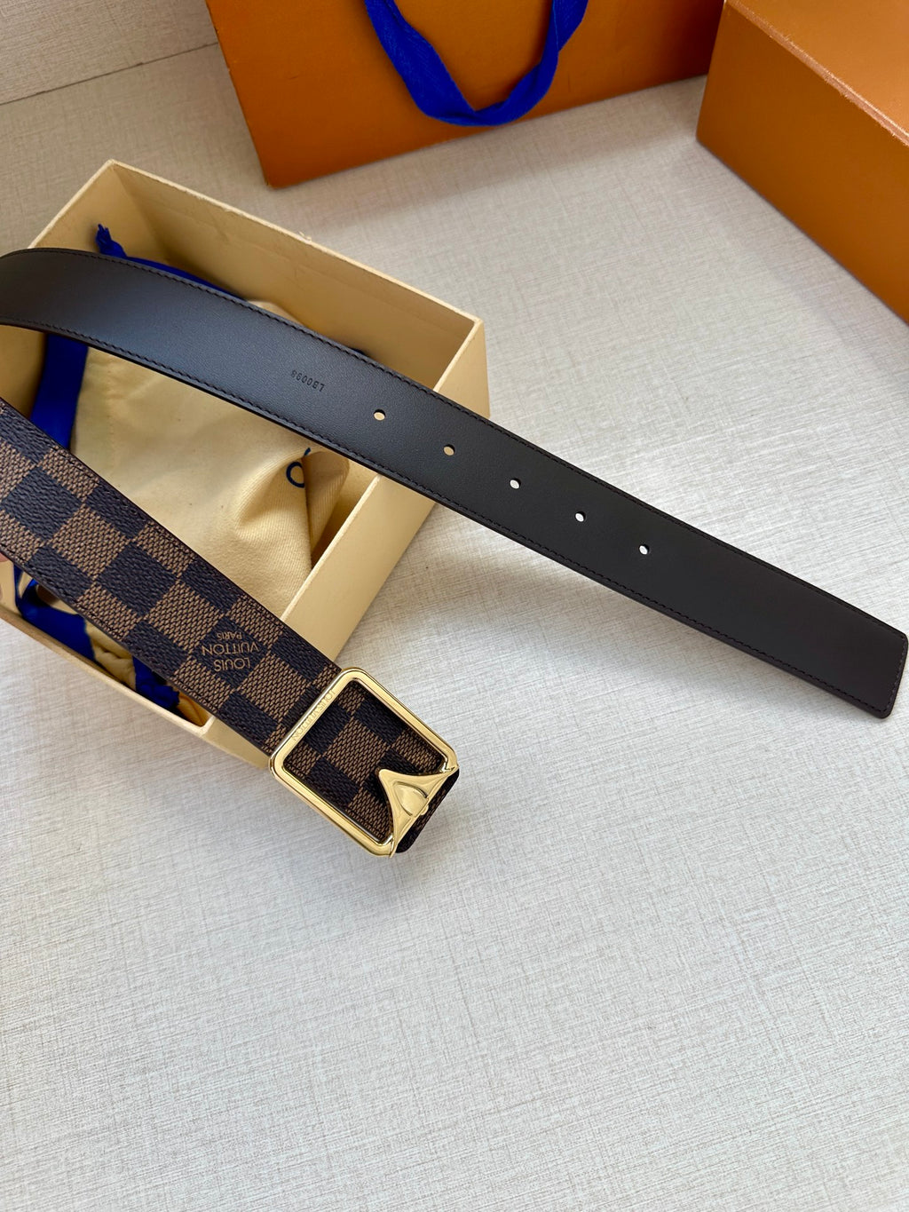 Black leather belt strap with button holes and Damier check buckle centerpiece