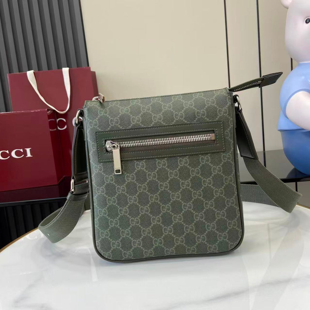 Crossbody bag with green GG-style monogram, front flap and silver zipper, adjustable strap
