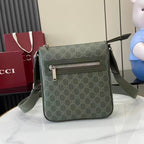 Crossbody bag with green GG-style monogram, front flap and silver zipper, adjustable strap