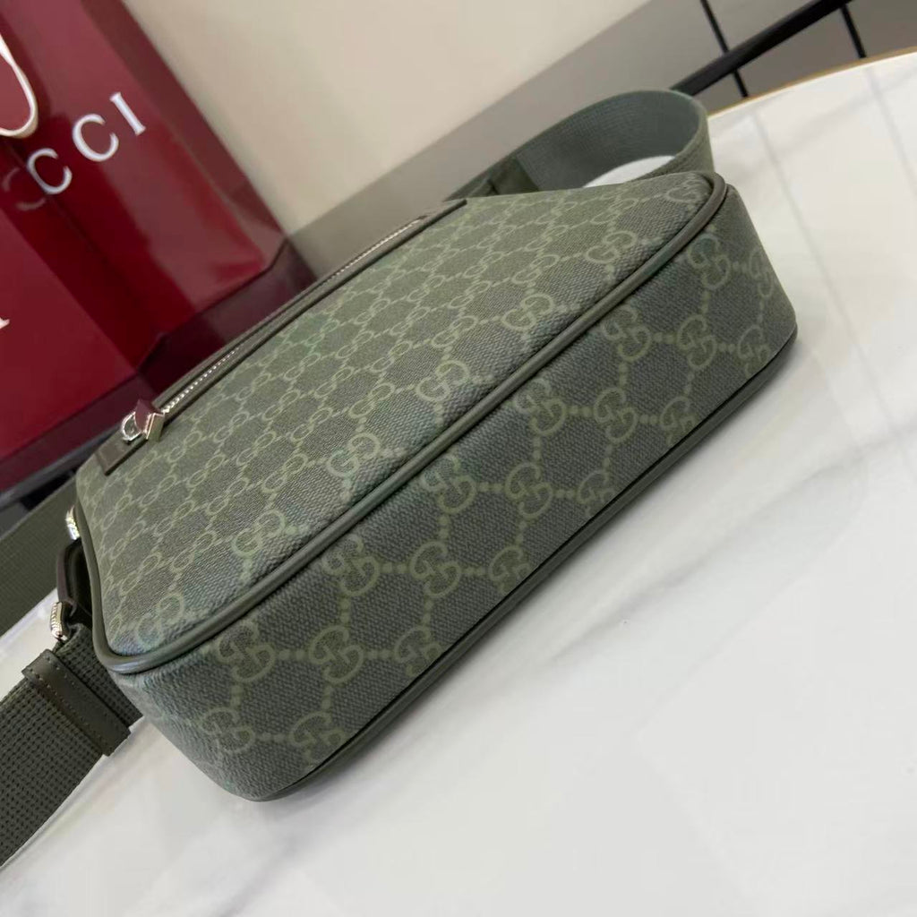 Crossbody bag with green GG-style monogram and long top zip detail